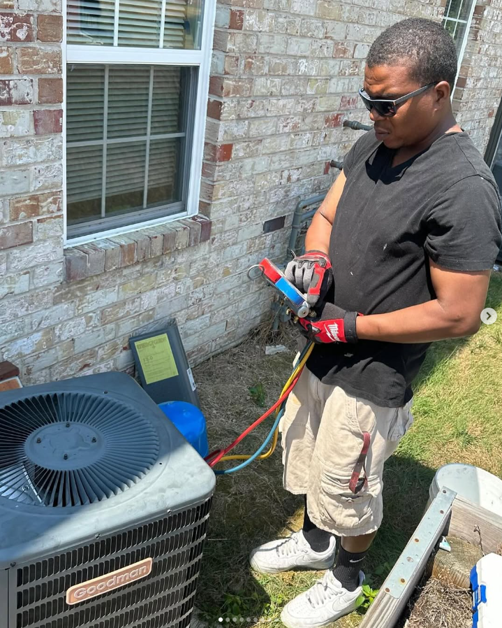 Pablo Martinez, owner of El Potro Heat & Cooling, servicing an outdoor AC condenser